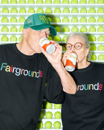 Two members enjoying drinks at a Fairgrounds event